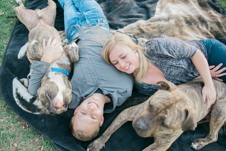 couple with their two dogs laying on a blanket at roosevelt park | Colorado outdoor wedding elopement engagement photography Denver, Rocky Mountains, Wyoming