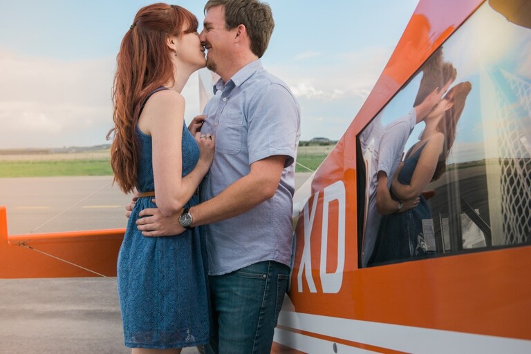 engagement photos next to a prop plane at the centennial airport in colorado | Colorado outdoor wedding elopement engagement photography Denver, Rocky Mountains, Wyoming